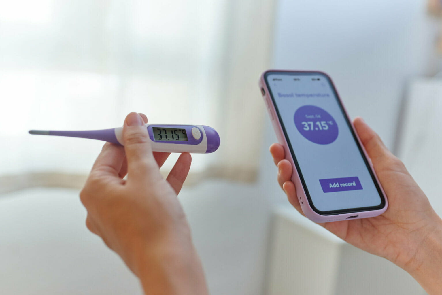 Close Up Of A Woman's Hands Taking Her Basal Temperature